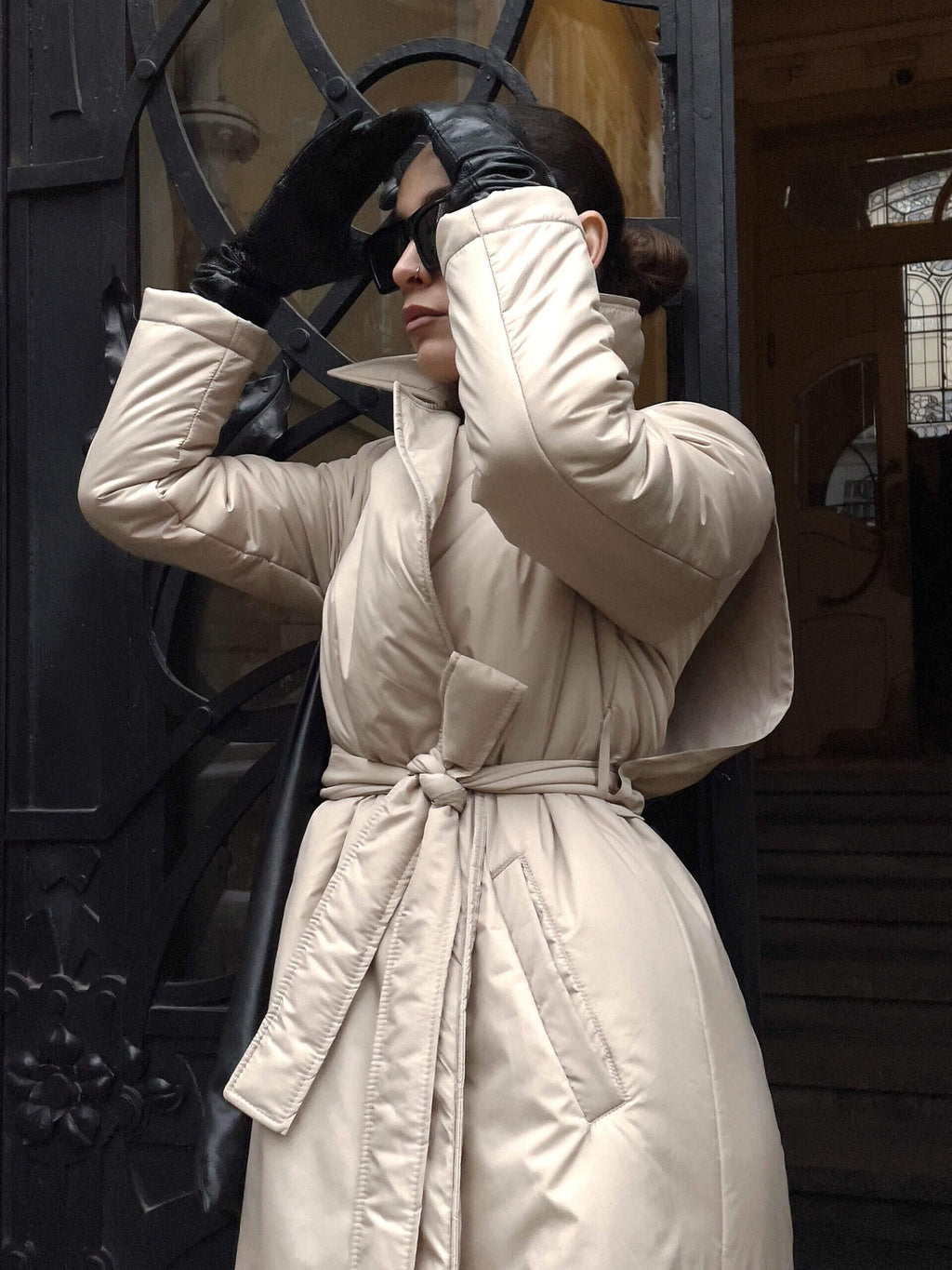 Бежеве довге стьобане пальто-тренч на жінці, теплий зимовий верхній одяг з високою горловиною, стильний бежевий пуховик для міста.